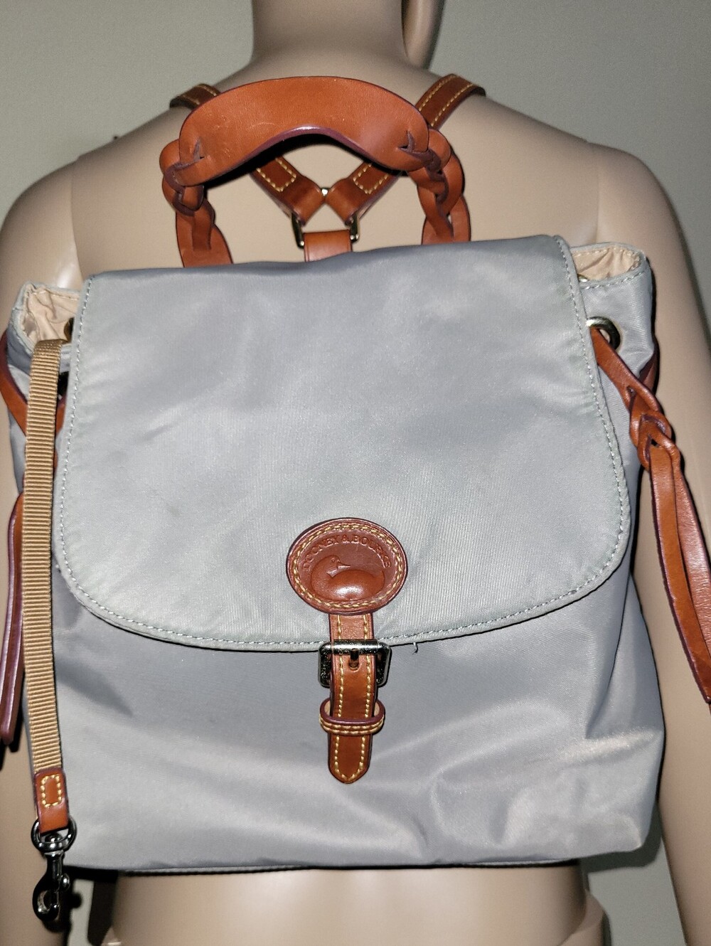 Dooney & Bourke Light Gray Nylon Backpack with Brown Leather Trim.